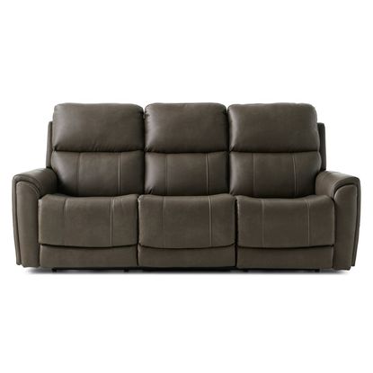 A contemporary three-seat power reclining sofa in a rich brown leather upholstery, featuring plush divided back cushions, flared pillow arms with subtle tufting, and sleek divided seats for enhanced comfort. The design includes adjustable headrests and lumbar pillows, a flip-down center console with cupholders and charging ports, all elevated on low block feet against a white studio background.