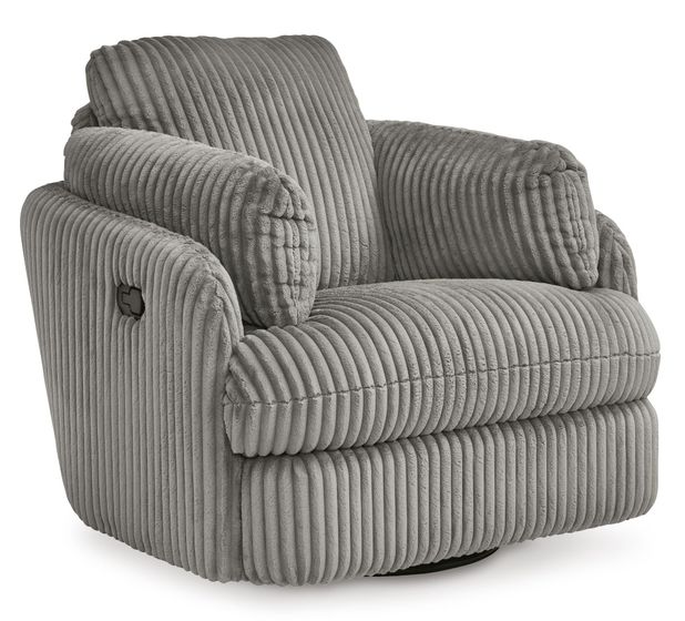 A cozy, modern armchair with a plush, ribbed fabric upholstery in a soft gray color. The chair features a wide, cushioned seat and backrest, with thick, padded armrests that curve gently outward for added comfort. The chair sits on a circular base, allowing it to swivel, and is set against a plain white background, highlighting its luxurious texture and contemporary style.